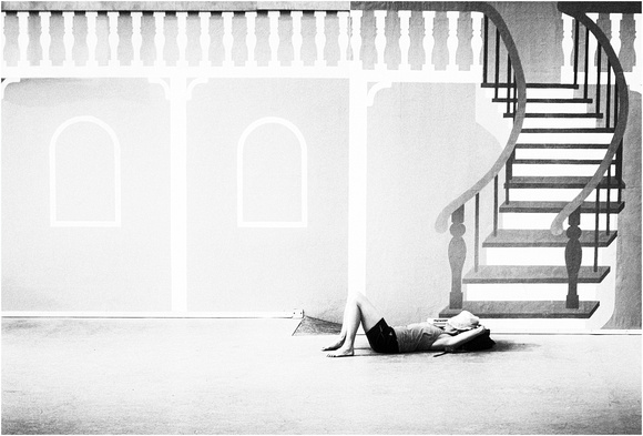 woman sleeping on stage below stairs PH2509a -4674